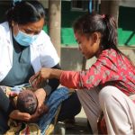 Anshu-Kumari-Dhyar-HDCS-baby-being-helped-by-staff-Edit